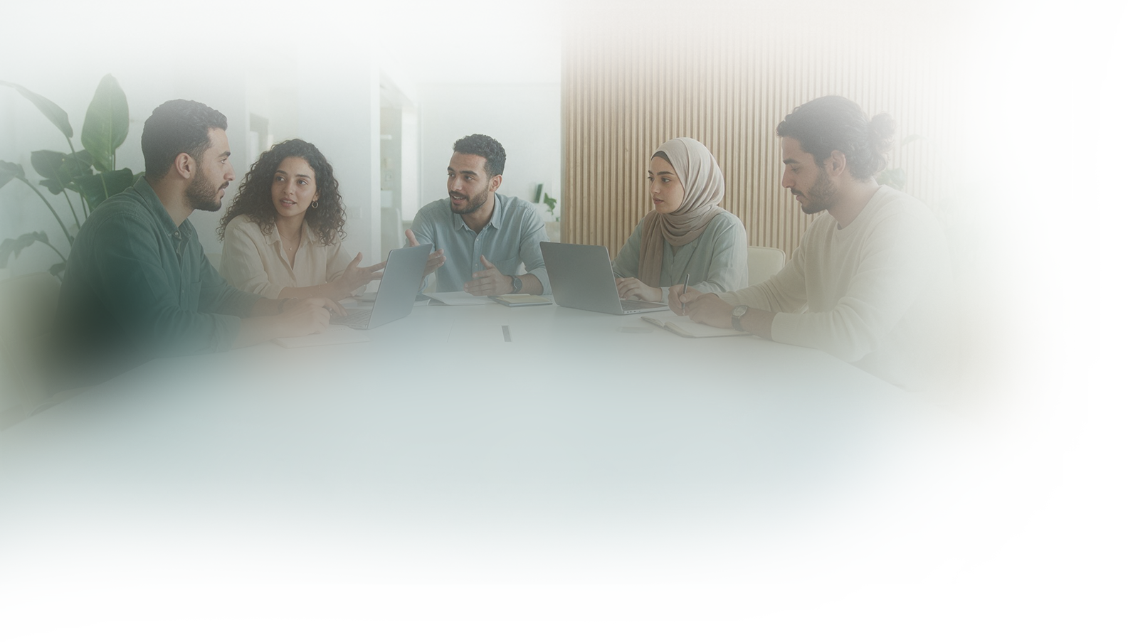 A group of learners discussing a project together